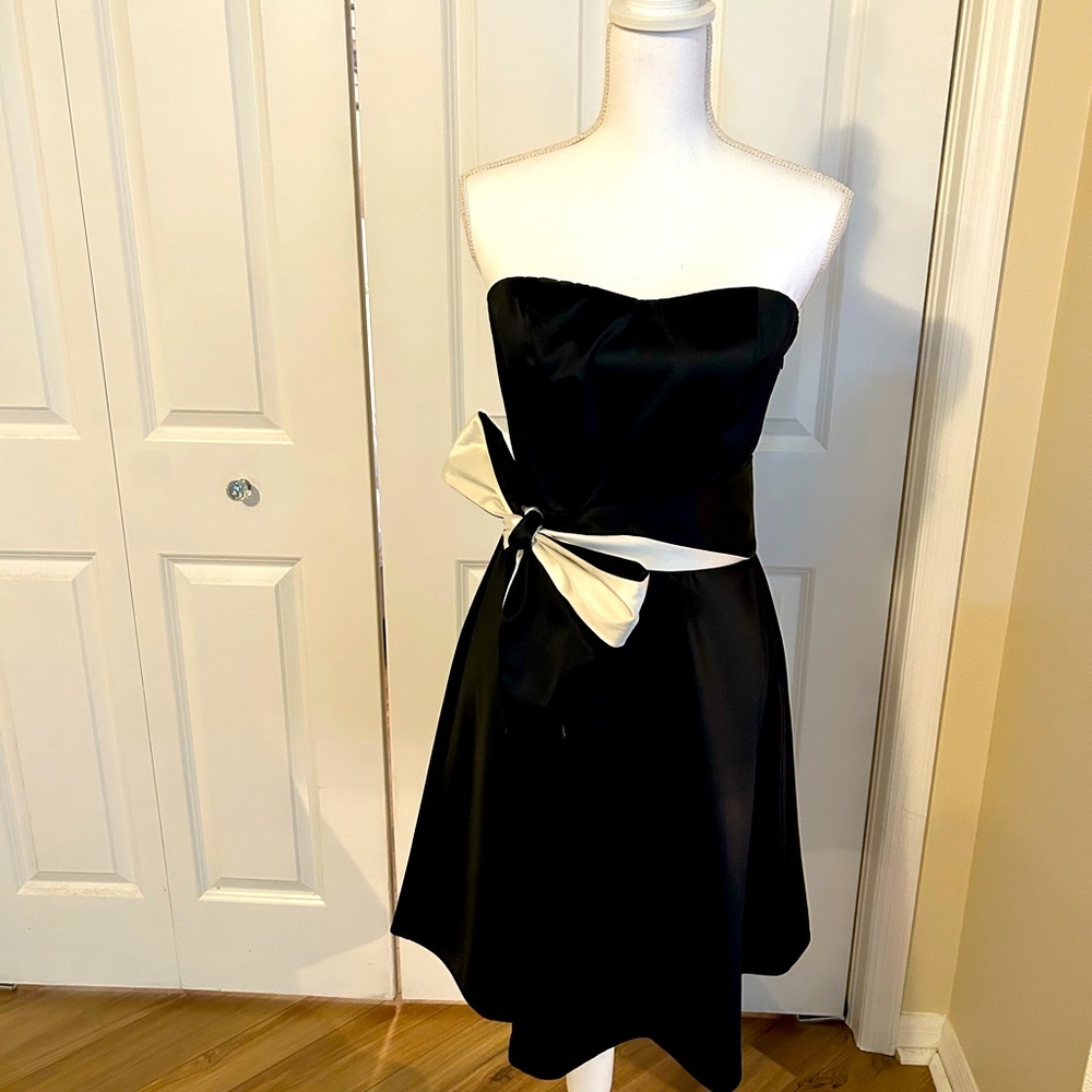 Women’s size 8 black dress with white sash.